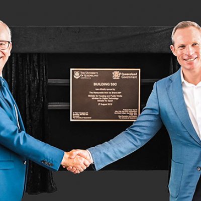 Minister for Sport Mick de Brenni and UQ Pro-Vice-Chancellor Professor Tim Dunne shake hands in front of the building plaque